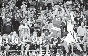  ?? JEFF CURRY, USA TODAY SPORTS ?? Wisconsin Badgers guard Bronson Koenig (24) shoots the game-winning shot over Xavier Musketeers guard Remy Abell (10) during the second round of the tournament last week.