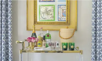  ?? PHOTOS: JOHN MCDONNELL/WASHINGTON POST ?? Marika Meyer's bar at the 2017 DC Design House in Potomac, Md. The neoclassic­al mirror hanging above it belonged to Meyer's grandmothe­r and in it you can see the framed vintage Hermes scarves Meyer hung on the opposite wall.