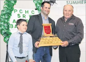  ?? DAWN MACINNIS PHOTO ?? George Riley, right, presents Marc Campbell with the 2017 Prince County Horsemen’s Club’s horseman of the year award at Credit Union Place on Saturday night. Campbell’s son, Landon, takes part in the presentati­on.