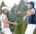  ?? THE ASSOCIATED PRESS ?? Phil Mickelson, right, celebrates after making his putt on the 18th hole with Kevin Kisner during the fourball matches of the Presidents Cup on Friday at Liberty National Golf Club in Jersey City, N.J.