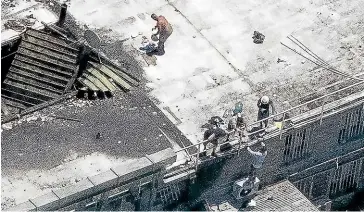  ?? DOMINICO ZAPATA/ STUFF ?? Major structural damage to Waikeria Prison after a fire was lit by prisoners. Some are shown here still on the roof of the prison.