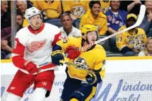  ?? AP PHOTO/MARK HUMPHREY ?? Detroit Red Wings right wing Anthony Mantha hits Nashville Predators center Matt Duchene with his stick during Saturday’s game in Nashville. Mantha was penalized for high-sticking.
