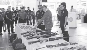  ?? ?? Philippine Army’s 301st Infantry Brigade commander Brigadier General Michael Samson and Police Regional Office 6 Brigadier General Jack L. Wanky present to the media the firearms and ammunition recovered following an encounter between the rebels and the Armed Forces of the Philippine­s and Philippine National Police in Barangay Torocadan, San Joaquin, Iloilo on February 28.
