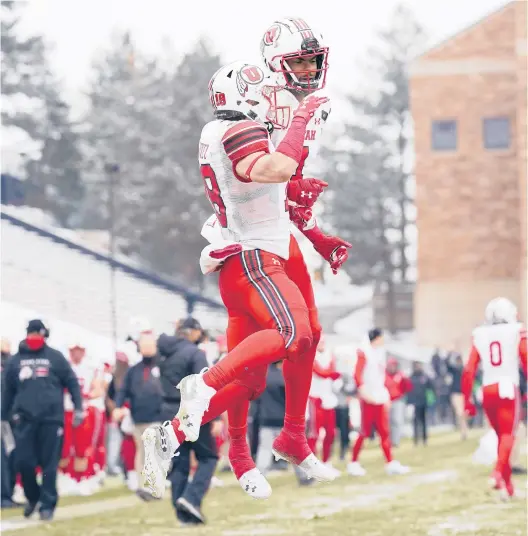  ?? DAVID ZALUBOWSKI/AP ?? Utah WRBritain Covey, front, celebrates with Bryan Thompson after a TD catch in Saturday’s victory over Colorado.