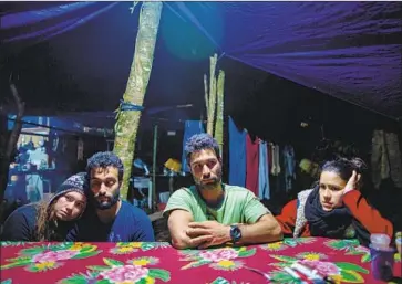  ?? Photograph­s by Flavio Forner For The Times ?? RESIDENTS Vanessa Muniz Honorato, left, Heber do Prado Carneiro, Edmilson de Lima Prado and Karina Ferro Otsuka, in a constituti­onal battle over land, rest at the camp in Jureia-Itatins Ecological Station.