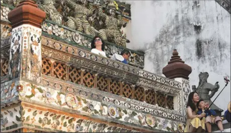  ?? ASSOCIATED PRESS ?? Chinese tourists take selfies at Wat Arun or the “Temple of Dawn,” on Jan. 12, in Bangkok, Thailand.