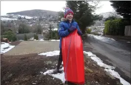  ??  ?? „ Eleven-year-old Lewis Campbell delivered groceries to neighbours using his sledge.