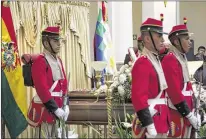  ?? JUAN KARITA / ASSOCIATED PRESS ?? An honor guard stands vigil over Bolivia’s Deputy Minister of Internal Affairs Rodolfo Illanes lying in state inside the government palace in La Paz, Bolivia, on Friday. Striking miners kidnapped and beat Illanes to death Thursday.