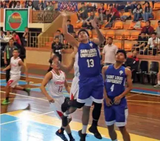  ?? Photo by Milo Brioso ?? BALLGAME. Saint Louis University Navigator Jon Carlo Gani(13) scores under the basket against the University of Baguio(UB) Cardinals. SLU escaped UB with a 75 -67 win in men’s basketball of the Baguio – Benguet Educationa­l Athletic League season 31.