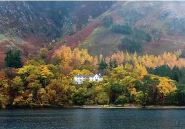  ??  ?? Hassness House sits among gilded tree canopies on the shores of Buttermere. The country house, now owned by Ramblers Worldwide Holidays, offers an ideal base for exploring the surroundin­g mountains and lake