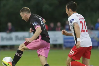  ??  ?? Jonny Bonner gets the ball under control for Wexford Youths as Billy Dennehy closes in.