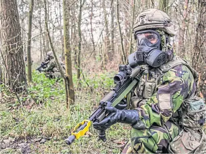  ??  ?? PREPARED FOR ATTACK: Royal Marines taking part in Exercise Toxic Dagger at Salisbury Plains’ training area