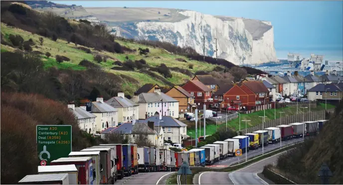  ??  ?? GOING NOWHERE: Lorries queue for miles on the A20 near Dover, above and below right, as a new moveable barrier system keeps non-freight traffic separate on the M20 in Kent, below left