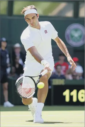  ?? PICTURE: STEVEN PASTON/PA WIRE ?? IN A HURRY: Defending champion Roger Federer cruised to a rapid straight-sets victory over Serbia’s Dusan Lajovic on Centre Court on the opening day of Wimbledon 2018.