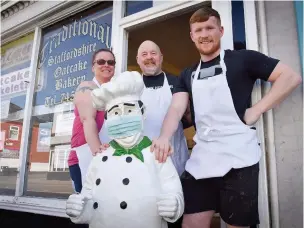  ??  ?? NEW GENERATION: Gary and Lisa Smith run with their son Chris outside the shop.