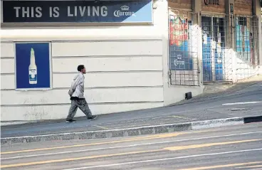  ?? /Reuters ?? A man passes by a central Cape Town liquor store closed after sales of alcohol were prohibited during the nationwide lockdown aimed at limiting the spread of the coronaviru­s disease, Covid-19.
All uphill: