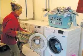  ?? ?? Sue Robinson hard at work in the Foxhangers laundry ensuring hire boat linen and towels are ready well in time for the next hire boat turnaround.