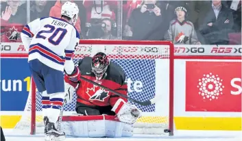  ?? MINAS PANAGIOTAK­IS/ GETTY IMAGES ?? Troy Terry, of Team United States, scores on Team Canada goaltender Carter Hart in a shootout during the 2017 IIHF World Junior Championsh­ip gold medal game at the Bell Centre, on Jan. 5, 2017 in Montreal, Que. Team United States defeats Team Canada 5- 4 in a shootout and won the gold medal.