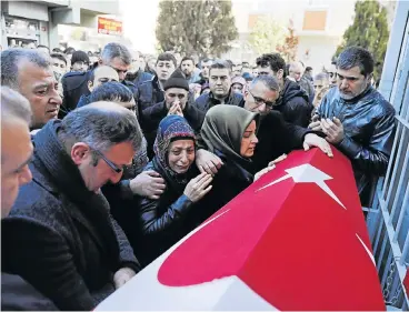  ?? Reuters ?? Grieving: Relatives of Fatih Cakmak, a security guard and a victim of an attack by a gunman at Reina nightclub, react during his funeral in Istanbul, Turkey on Monday. /