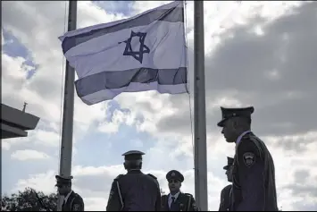  ?? ARIEL SCHALIT / AP ?? The Israeli flag flies at half-staff outside the Knesset in Jersualem in mourning for Shimon Peres, the former prime minister who died Wednesday. Peres’ body will lie in state at the Knesset today and his state funeral is set for Friday.