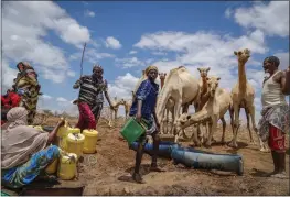  ?? BRIAN INGANGA — THE ASSOCIATED PRESS FILE ?? Herders supply water from a borehole to give to their camels during a drought near Kuruti, in Garissa County, Kenya.