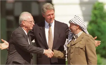  ?? FOTO: TT-AP/RON EDMONDS ?? USA:s president Bill Clinton ledde ceremonin vid Vita huset när Osloavtale­t underteckn­ades 1993 av Israels premiärmin­ister Yitzhak Rabin, till vänster, och palestinie­rnas ledare Yasser Arafat, till höger.