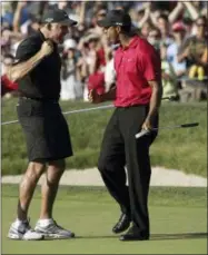  ?? CHRIS O’MEARA — THE ASSOCIATED PRESS FILE ?? In this file photo, Tiger Woods celebrates with his caddie, Steve Williams, after sinking a birdie putt on the 18th green, forcing a playoff against Rocco Mediate, during the fourth round of the U.S. Open golf tournament at Torrey Pines in San Diego....