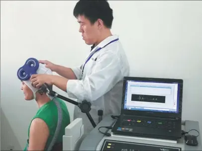  ?? PROVIDED TO CHINA DAILY ?? A doctor in one of Shanghai’s rehab centers fits a VR helmet on a patient to test his addiction levels.