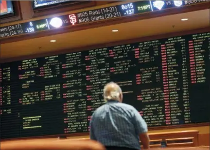  ?? JOHN LOCHER — THE ASSOCIATED PRESS ?? Betting odds are displayed on a board in the sports book at the South Point hotel and casino in Las Vegas.