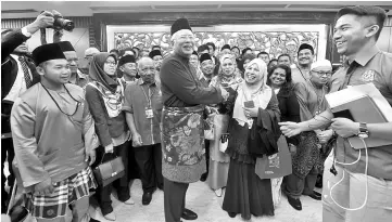  ??  ?? Prime Minister Datuk Seri Najib Tun Razak greeting civil servants from various ministries upon leaving Parliament after tabling Budget 2018. - Bernama photo