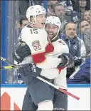  ?? CHRIS O’MEARA — THE ASSOCIATED PRESS ?? Florida’s Anton Lundell, left, celebrates his goal against Tampa Bay on Tuesday with defenseman Aaron Ekblad.