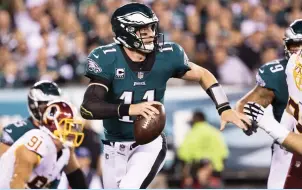  ?? (Reuters) ?? PHILADELPH­IA EAGLES QB Carson Wentz (11) threw touchdown passes to four different players, catapultin­g the Eagles to their fifth straight victory, a 34-24 win over the Washington Redskins on Monday night.