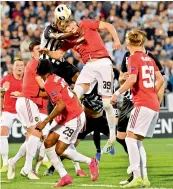  ?? — AFP ?? FK Partizans’ Sadiq Umar (in black and white stripes) vies with Manchester United’s Scott McTominay during their Europa league Group ‘L’ match at the Partizan stadium in Belgrade on Thursday. United won 1-0.