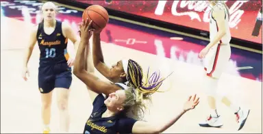  ?? David Butler II / USA Today ?? Marquette’s Liza Karlen, bottom, battles for a rebound against UConn’s Aaliyah Edwards in the second quarter at Gampel Pavilion on Monday.
