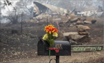  ?? ?? Flowers are added to a mailbox in Klamath River on Thursday near the site of where two people died in the McKinney fire.