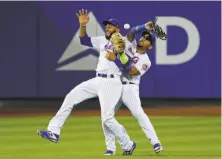  ?? Frank Franklin II / Associated Press ?? Amed Rosario (left) and Dominic Smith of the Mets collide and drop Brandon Crawford’s pop-up in the 13th inning.