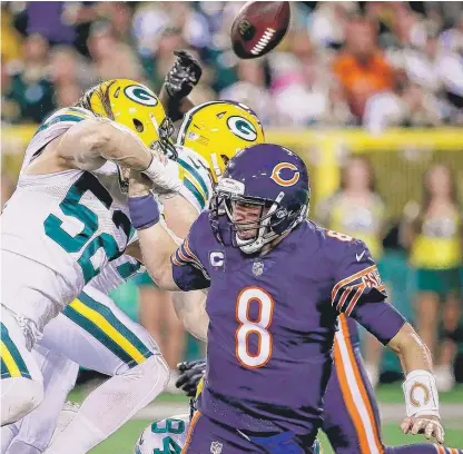  ??  ?? The Packers’ Clay Matthews ( 52) forces a fumble by Bears quarterbac­k Mike Glennon in the first quarter Thursday. | GETTY IMAGES