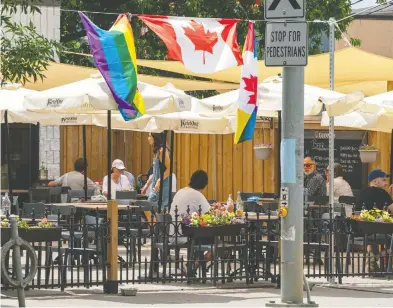  ?? FRANK GUNN / THE CANADIAN PRESS FILES ?? Patios are opening at a lot of restaurant­s but they can be at the mercy of weather — if it rains,
they’re generally closed and if it’s too hot no one wants to sit in the sun.