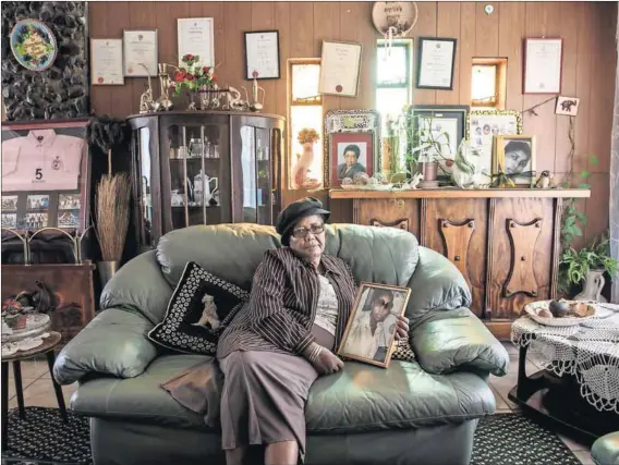  ?? Photos: Troy Enekvist ?? Truth: Ernestina Simelane holds a photo of her daughter, Nokuthula, who was tortured and murdered. The family has experience­d 30 years of distress in their search for her body and seeking the prosecutio­n of her killers. A statue of the MK cadre stands...