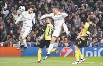 ??  ?? Borja Mayoral (left) and Ronaldo (second right) and in action with Borussia Dortmund’s Raphael Guerreiro (right) during the UEFA Champions League Group H match at the Santiago Bernabeu stadium in Madrid. — Reuters photo