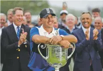  ?? JULIO CORTEZ/ASSOCIATED PRESS ?? Brooks Koepka poses with the Wanamaker Trophy after winning the PGA Championsh­ip.