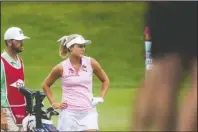  ?? The Associated Press ?? ROUGH TRIP: Lexi Thompson of Florida watches another golfer on July 18 during the second round of play of the Dow Great Lakes Bay Invitation­al at Midland Country Club in Midland, Mich. Thompson has not fared well while overseas, missing the cut at Evian and forgetting her passport in her golf bag, causing a delay that left all golfers without the ability to play a practice round Monday.