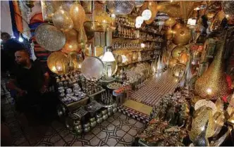  ??  ?? Brass and copper items, as well as lanterns, in one of the shop in Medina’s Souk.