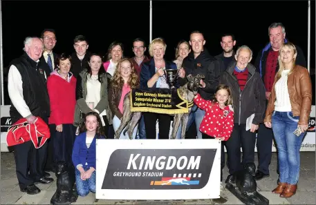  ??  ?? Mary Kennedy, centre, representi­ng the Kennedy family, presents the winner’s trophy to winning owner John Geoghegan after Slippy Maska won the Steve Kennedy Memorial Final at the Kingdom Greyhound Stadium on Friday. Included from left are Joe Carey,...