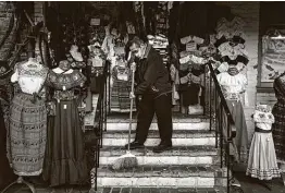  ?? Jae C. Hong / Associated Press ?? Victor Flores, 66, a third-generation owner of a gift shop, sweeps the steps of his store on Olvera Street in downtown Los Angeles last month.