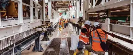  ??  ?? MRT crew inspecting the installati­on of pipes for TBM grouting. Tunnellers trained at TTA are capable of managing tunnelling works as well as the groundwork­s.