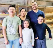  ?? STAFF PHOTO BY C.B. SCHMELTER ?? Amando, back right, and Mariola pose with their children Daniel, Ariana and Chris at Chris Bakery on March 25.