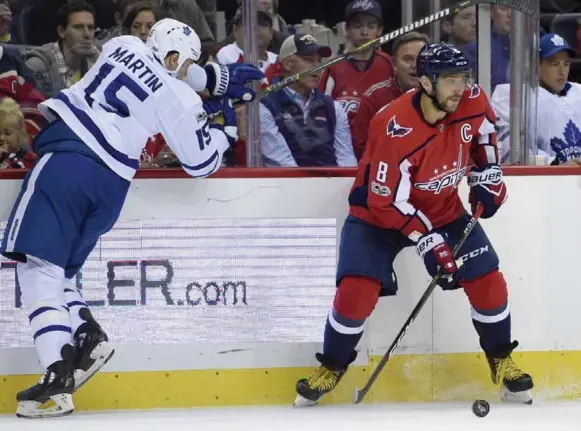  ?? NICK WASS/THE ASSOCIATED PRESS ?? The Leafs’ Matt Martin is a little wide left as he tries to check Washington’s Alex Ovechkin. The Leafs cooled off the Capitals star Tuesday, limiting him to four shots in a 2-0 win.