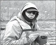  ?? Arkansas Democrat-Gazette/BRYAN HENDRICKS ?? Rusty Pruitt of Bryant admires one of the many rainbow trout he caught on the White River last Sunday.