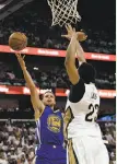  ??  ?? Warriors forward Draymond Green, who had a double-double with 22 points and 10 rebounds, drives past Anthony Davis. Stephen Curry launches a shot over Davis, who led the Pelicans with 36 points.